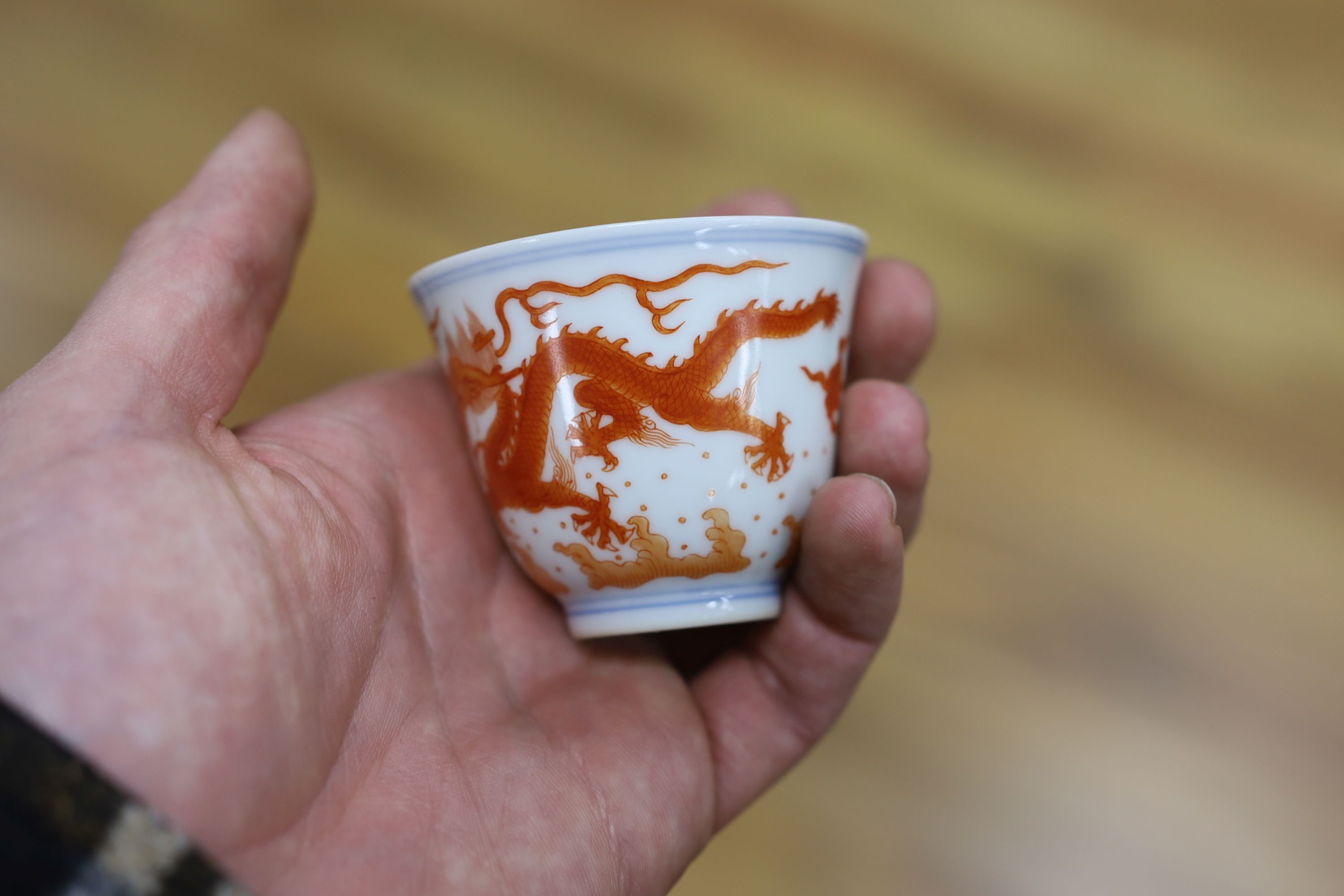 A Chinese iron red enamelled ‘dragon’ tea bowl, 5cm high